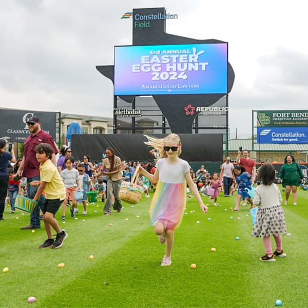 Kids hunting for 15,000 Easter eggs at the Amaro Law Firm Easter Egg Hunt
