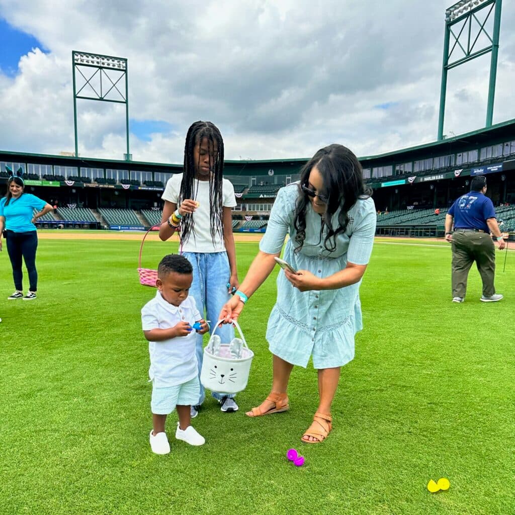 Children collecting eggs at the Amaro Law Firm Easter egg hunt