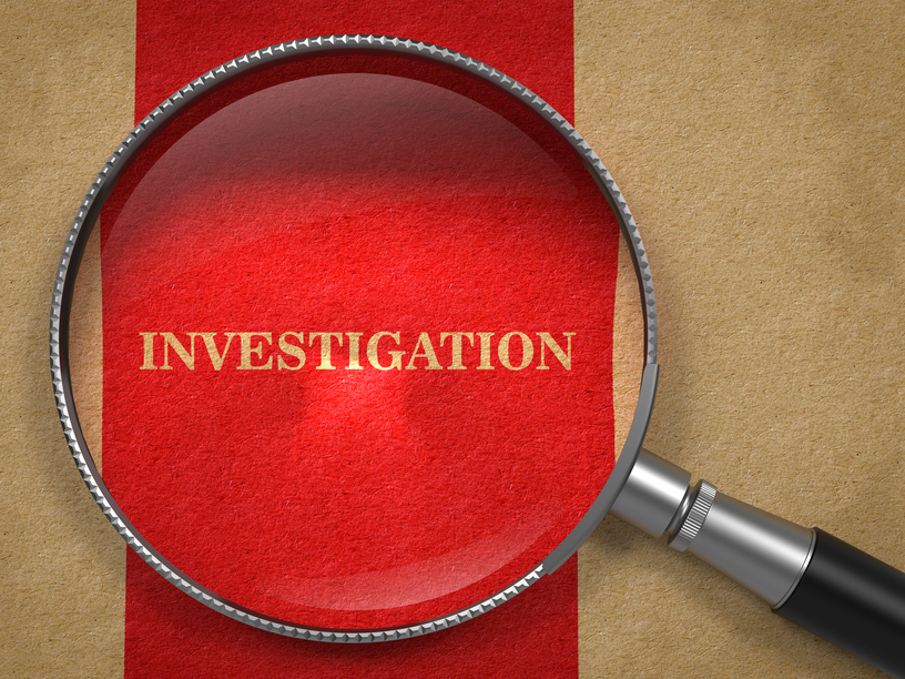investigation magnifying glass on old paper.
