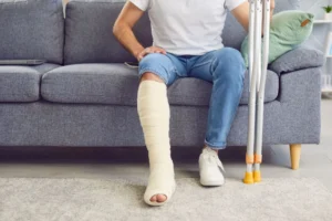 A man in a leg cast who has experienced a significant injury