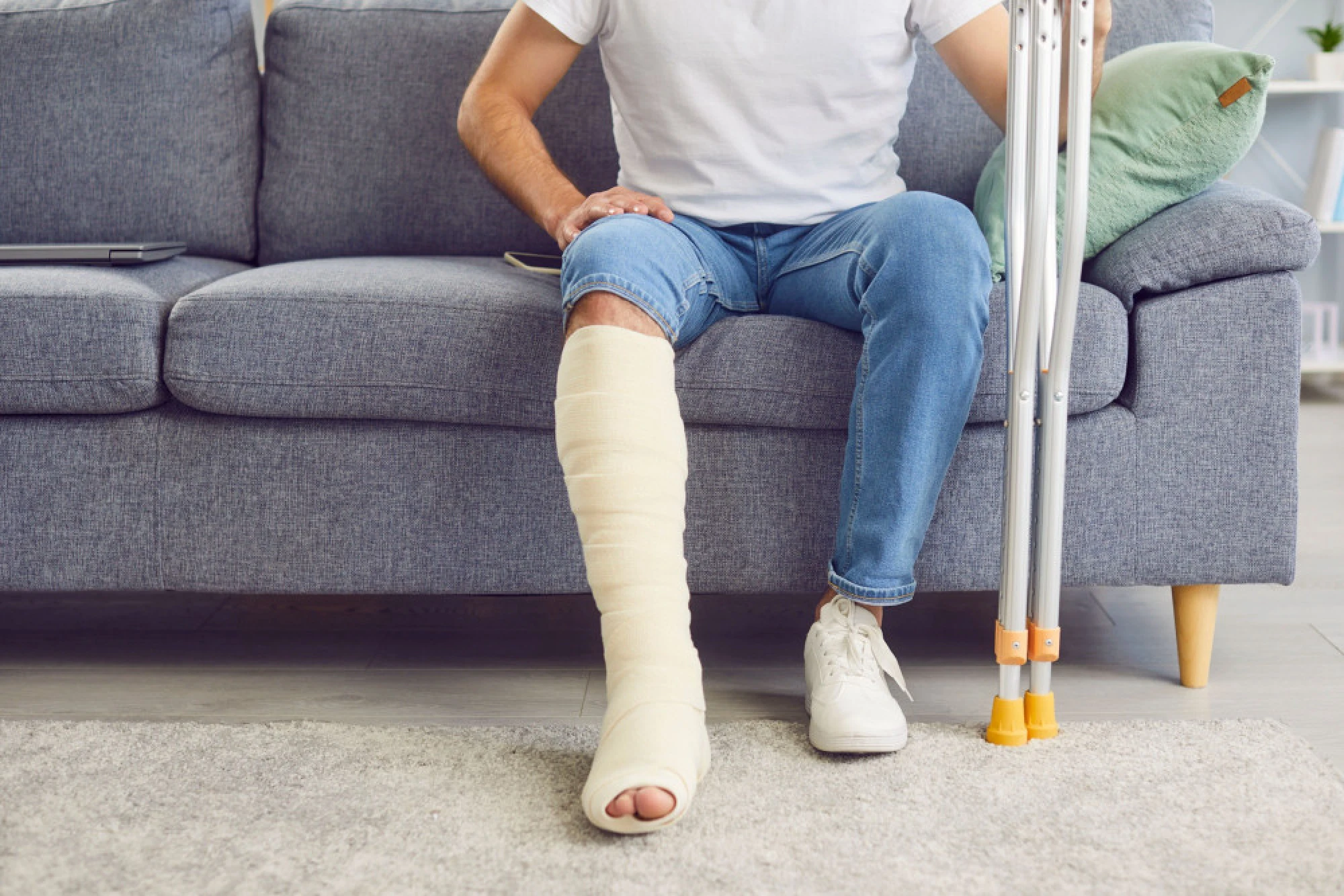 A man in a leg cast who has experienced a significant injury